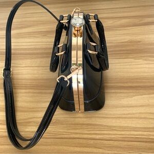 Shiny black handbag with gold hardware